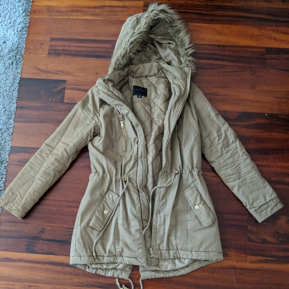 Tan parka with furry hood and gold details